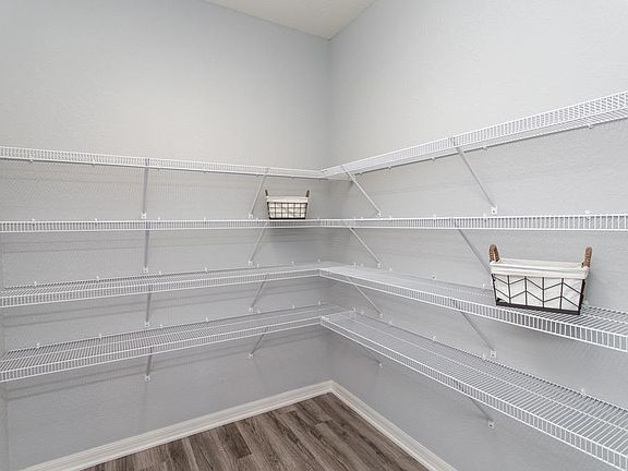Large walk-in pantry - New home for sale in Lakeland, FL. Photos showcase a home with similar finish