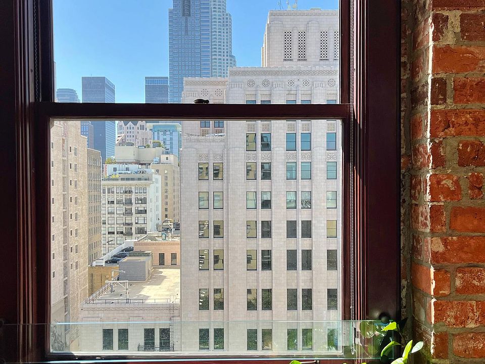 Original exposed brick, oversized mahogany-framed windows and the unbeatable DTLA view at the Rowan Building #1001