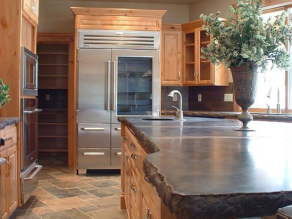 Kitchen with Subzero refrigerator and slate flooring