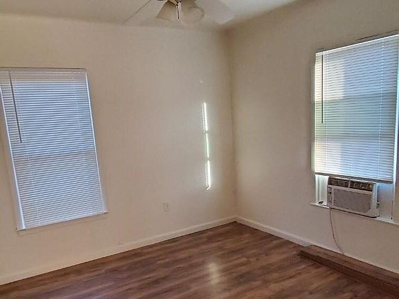 Bring and roomy bedroom with New window AC and ceiling fan.