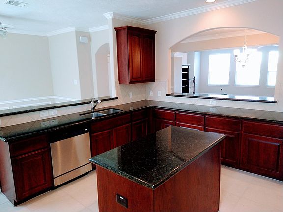 Large kitchen island with storage and electrical outlet.