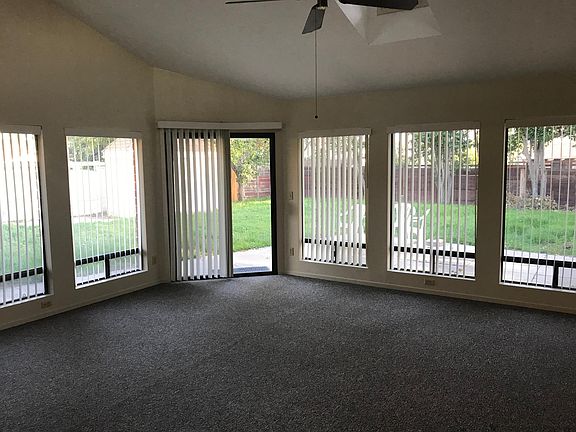 Livingroom with new carpeting, and sliding glass door access to large backyard.
