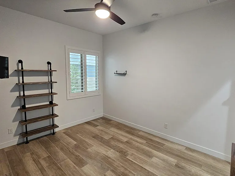 Office with built in shelves and mounted TV
