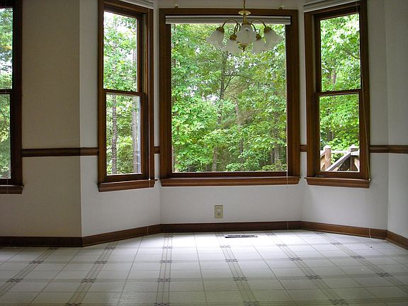 Breakfast nook with picture window and wooded view