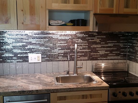 Recently remodeled kitchen, glass tile, dishwasher, stove, oven.