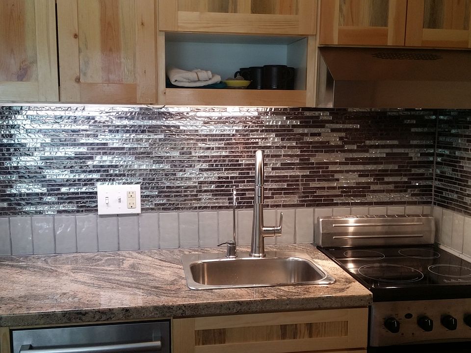 Recently remodeled kitchen, glass tile, dishwasher, stove, oven.
