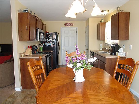 A view of the Breakfast room and Kitchen from the deck. The door in the background leads to the laundry area and the door to the