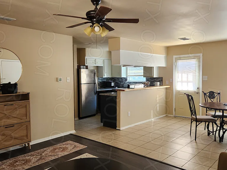 Living room view of eating area and kitchen.