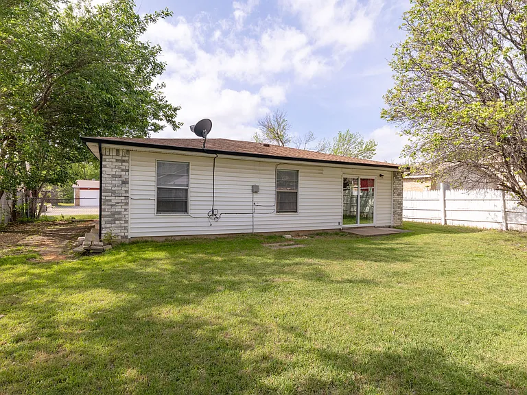 Large fenced-in backyard, offering plenty of room for outdoor relaxation and fresh air.