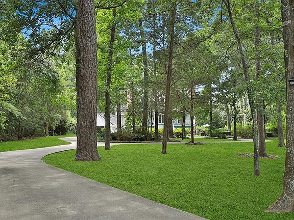 Wooded park like drive up to this gorgeous home is frequented by the local deer