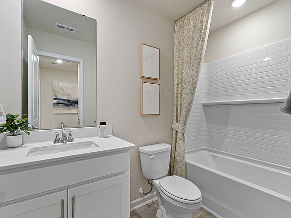 A secondary bathroom is located adjacent to the secondary bedrooms.