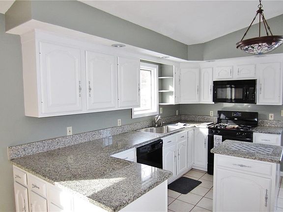 Updated Kitchen with Beautiful Granite Counter Tops, Breakfast Bar, Cathedral Ceilings Ceramic Tile Floor and All Appliances Remain!