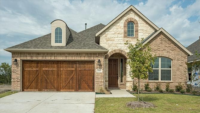 exterior with cedar garage door