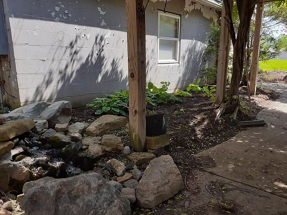 Water feature. Tenants on first and second story. Attached shop for Side Door Strings luthier business.
