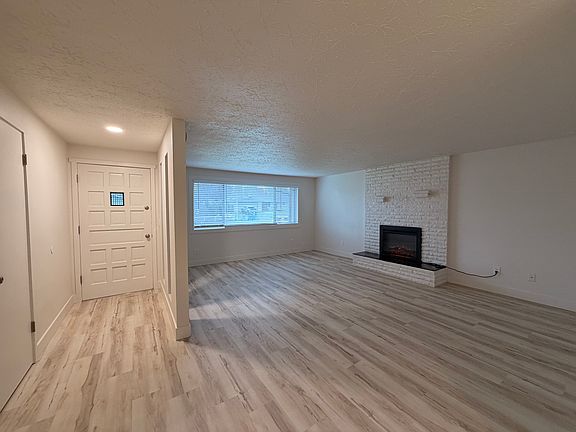 Large Open Concept with charming fireplace and tile