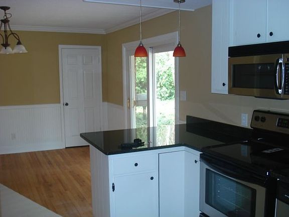 Geogeous Kitchen with Fridgedaire Stainless Appliances and Black Granite.