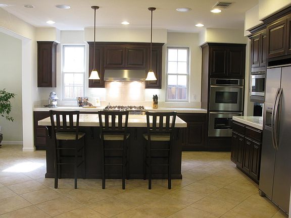 Open floor plan to large adjoining living room w/ huge chef's kitchen and Thermador Stainless Steel appliances