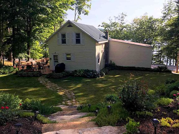 Lush green lawn with stone landscaping and perennials