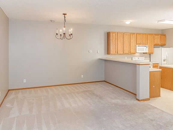 A nice dining area with breakfast bar and updated chandelier.