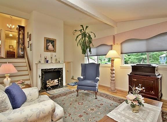 Sun filled living room is accented with hardwood flooring.