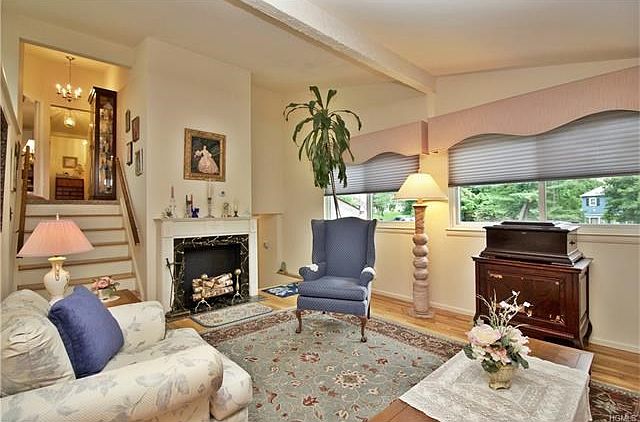 Sun filled living room is accented with hardwood flooring.