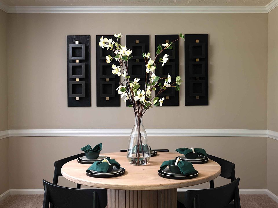 Dining area with crown molding and chair rail