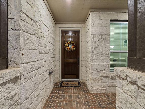 The Stone and Brick Entrance showcases the Eight Foot Mahogany Door beautifully. The Porch to the right is also large enough to put some seating if you like to enjoy the outdoors.