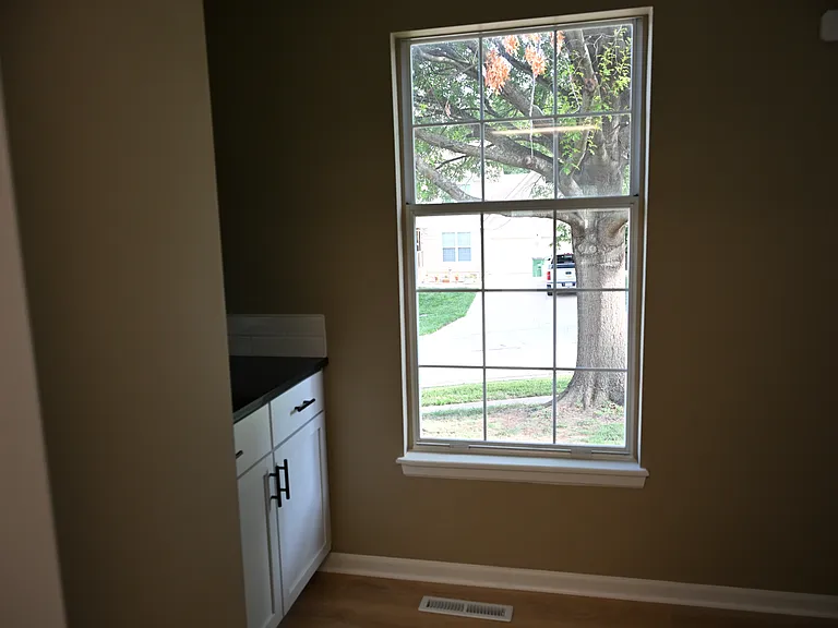 View of butler pantry area in laundry. Shelves being added above cabinet.