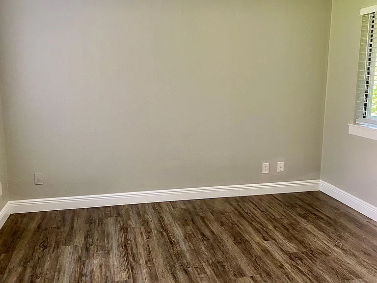 Large bedroom with double doors open to living space.