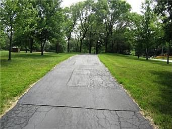 WINDING DRIVEWAY W/ MATURE TREES