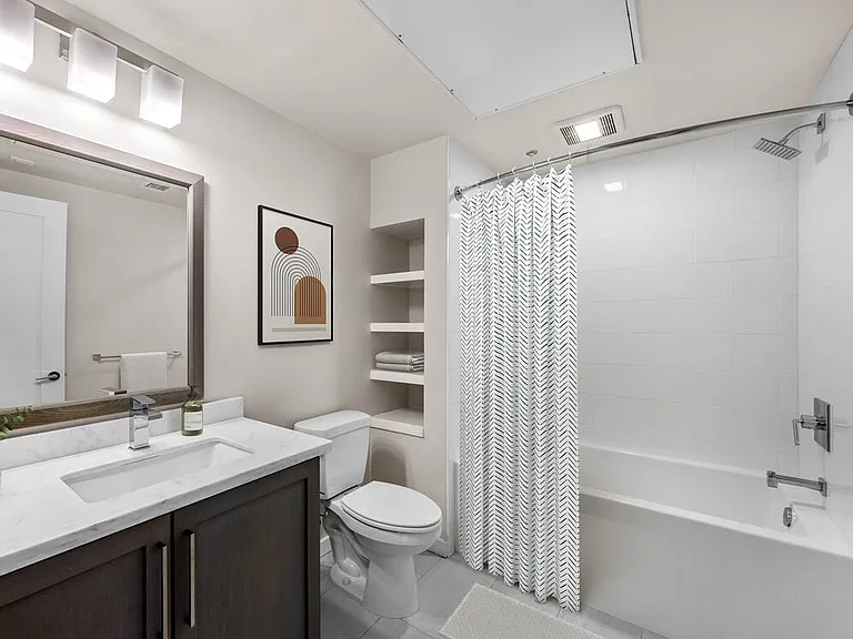 Baths with dark cabinetry, white quartz countertops, and hard surface flooring