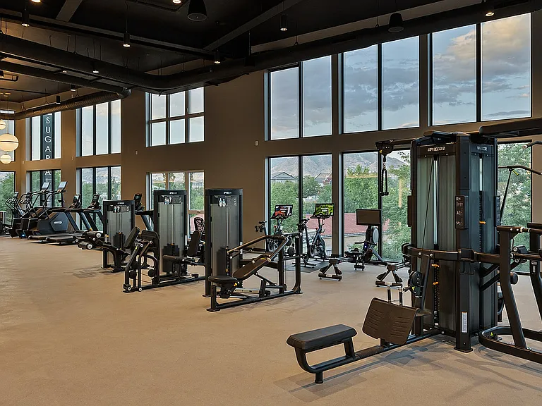 Evening view of the fitness center with floor-to-ceiling windows