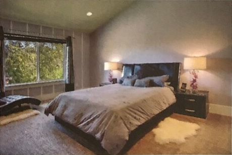 Upstairs master bedroom with vaulted ceiling. Window with view of large backyard and greenbelt