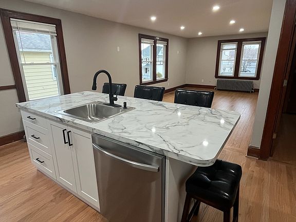 Kitchen island with sink and dishwasher.