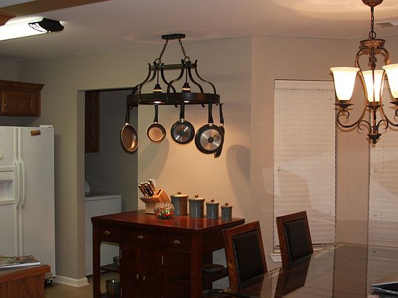 shot of kitchen looking at pot rack and island