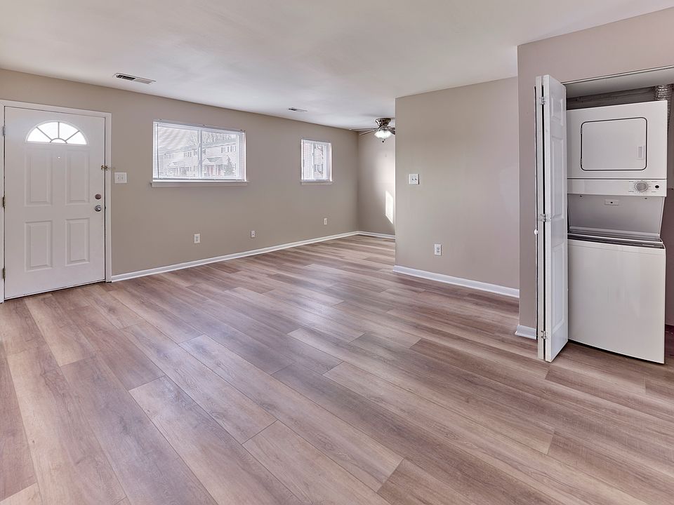 Spacious living area with natural light and in-home washer and dryer at Village Square.