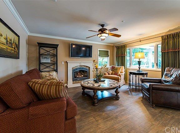 The Family Room is warmed by the look of "wood like" ceramic tile and a gas heating fireplace.