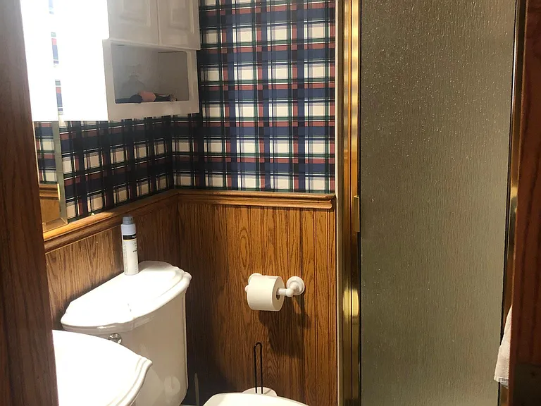 Large shower with wooden floor bathroom.