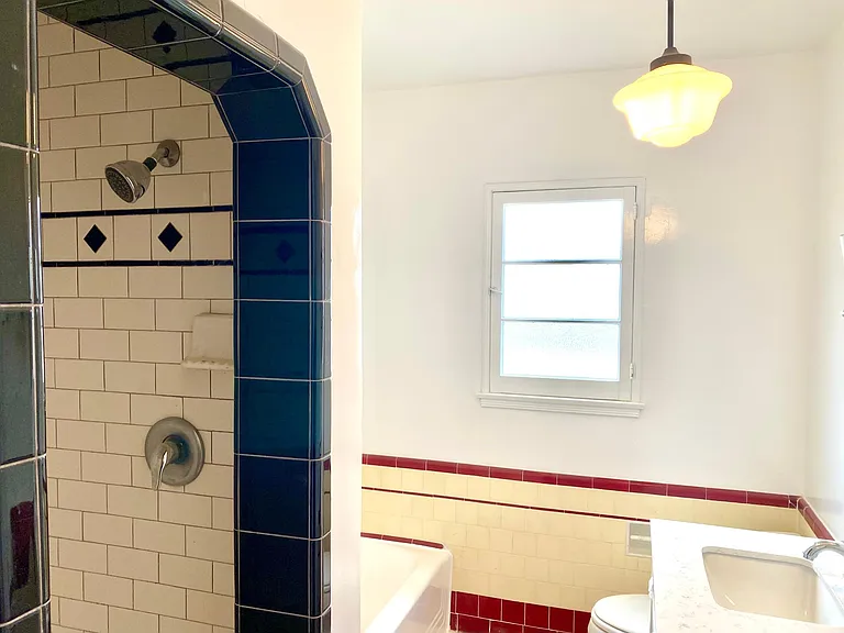 tiled bathroom with tub and shower
