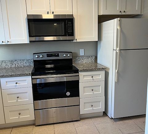 Kitchen with microwave over stove/oven.