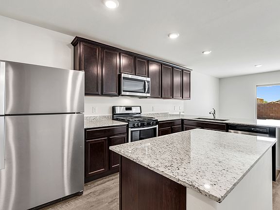 Chef-ready kitchen with stainless appliances and a large island.