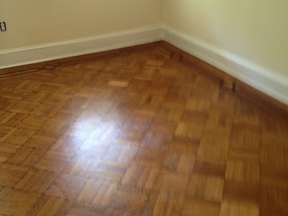 Partial area of bedroom, large enough for 1 queen bed, chair, night table, desk and chair. View of street