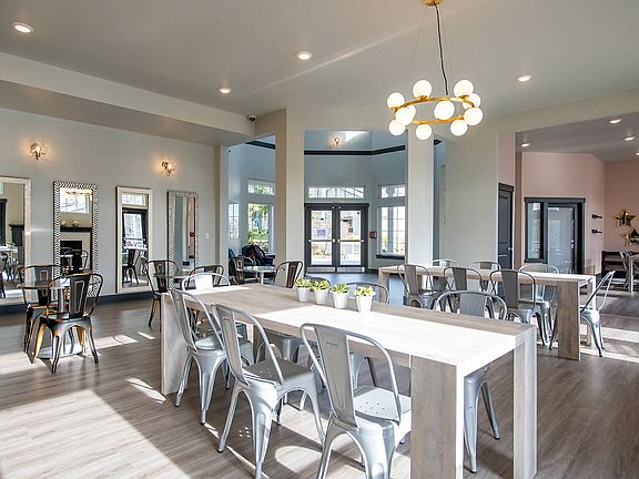 Clubhouse with hardwood-style flooring and dining table.