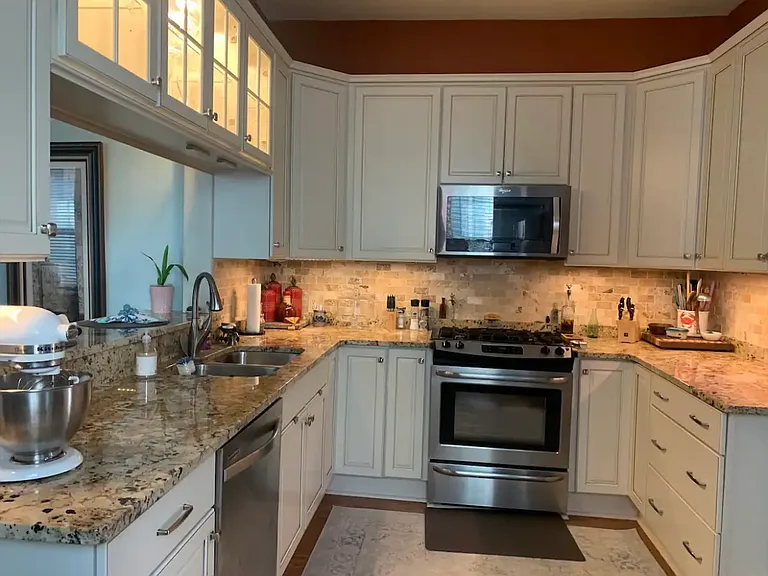 Granite countertops with stainless steel appliances.