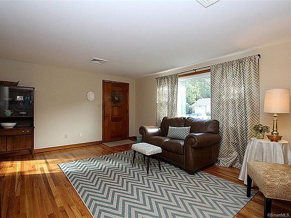 The front door leads into the light-filled living room with gorgeous oak hardwood floors.