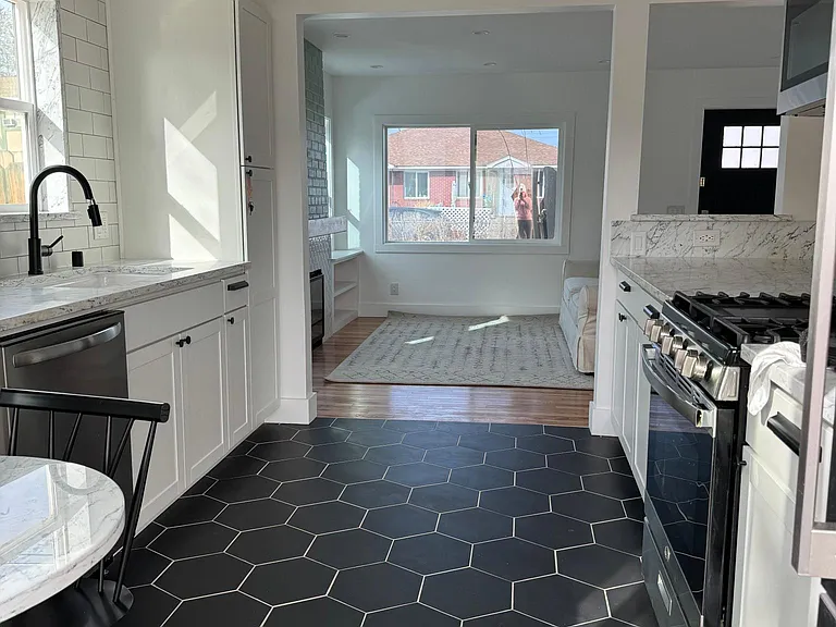 View from kitchen into living room area. Fully renovated with brand new appliances and dining nook.