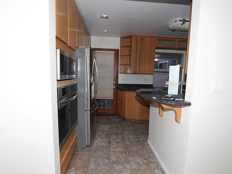 Kitchen facing the kitchen access door.