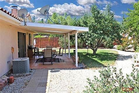 ONE VIEW OF THE BACK YARD AND ONE OF THE TWO PATIOS!