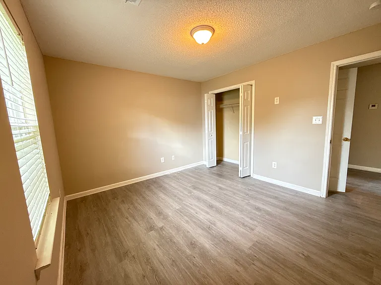 Another angle of the second bedroom showcasing the spacious closet and excellent natural light.
