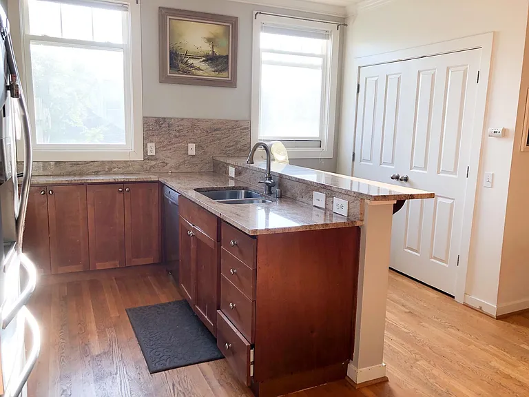 Double door pantry adjacent to kitchen. Counter perfect for bar stool seating